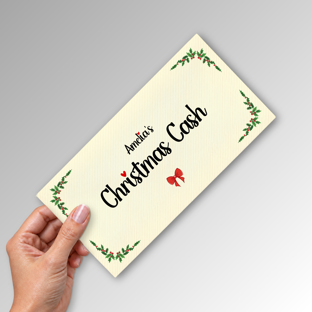 Ivory DL Christmas cash envelope with Amelia's print, held in a hand