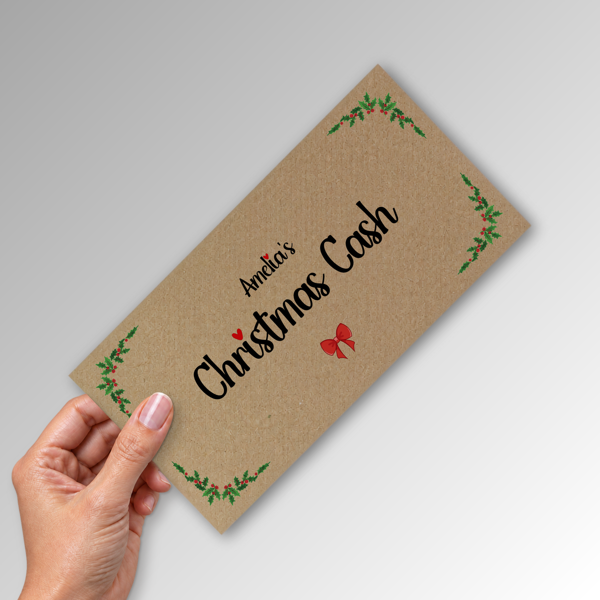 Kraft DL Christmas cash envelope with Amelia's print, held in a hand
